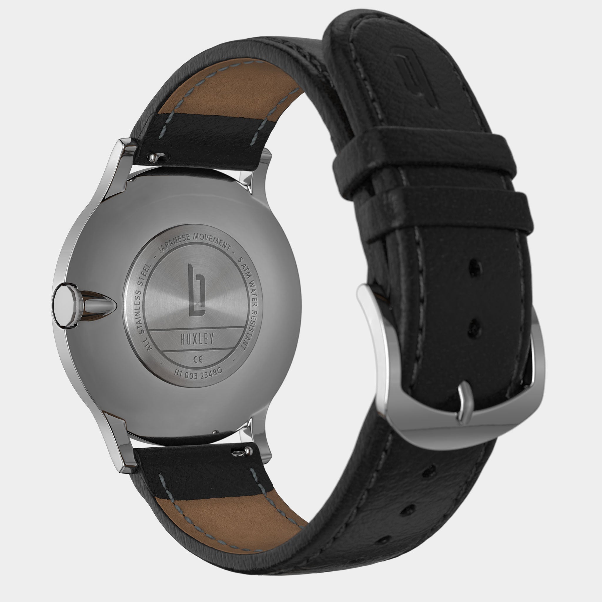 Back view of stainless steel watch with black leather strap and engraved case details