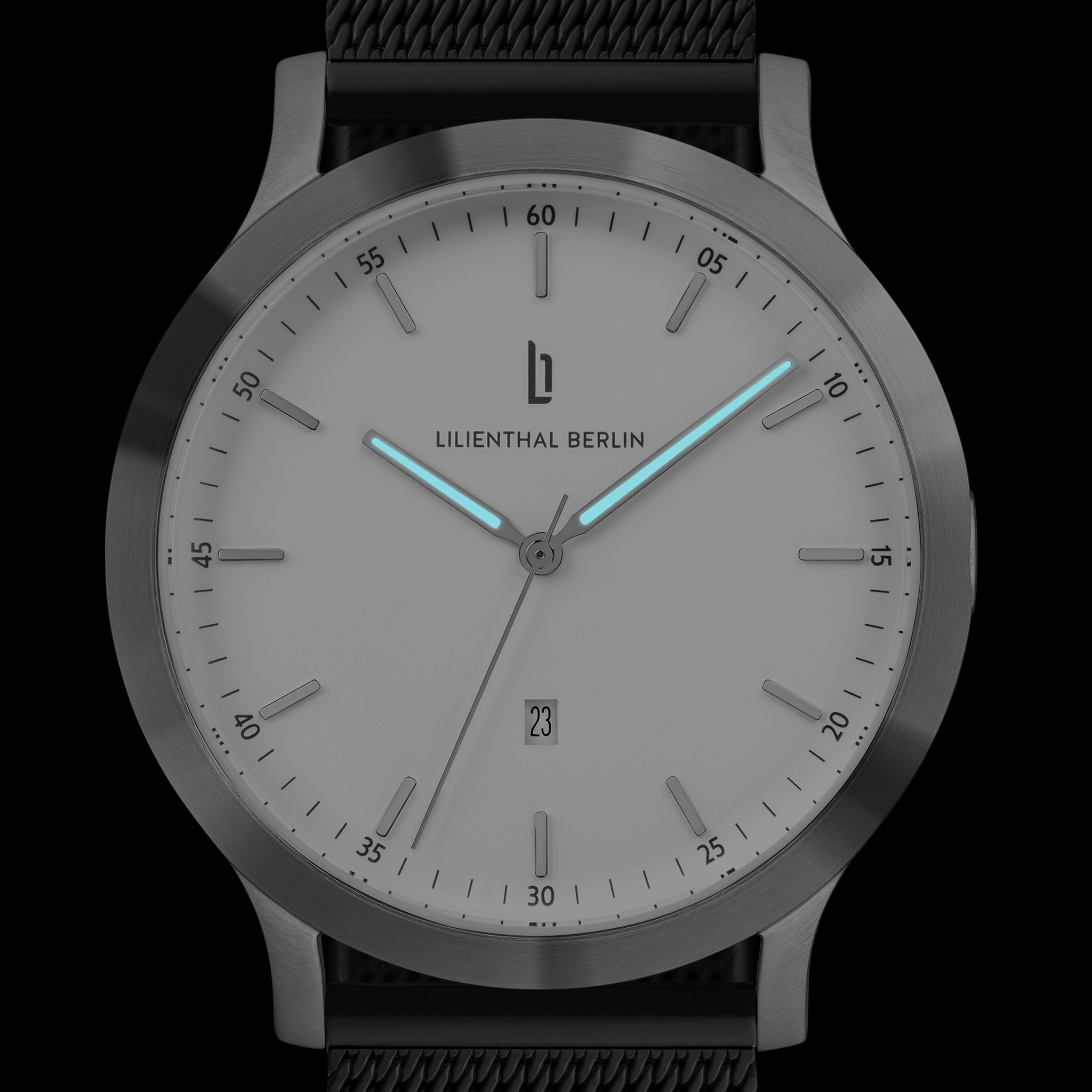 Minimalist silver wristwatch with glowing blue hands, mesh strap, and date display