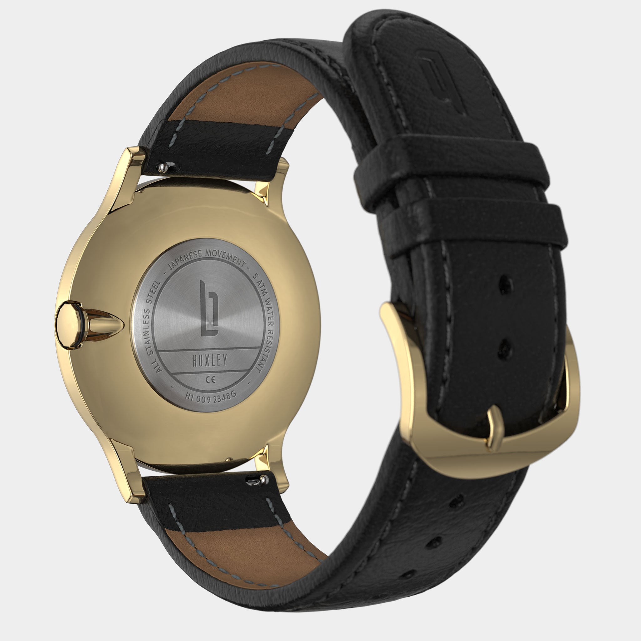 Gold stainless steel watch case with black leather strap, engraved back, and gold buckle