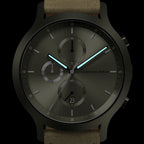 Modern chronograph watch with black case, brushed metal dial, and glowing blue hands