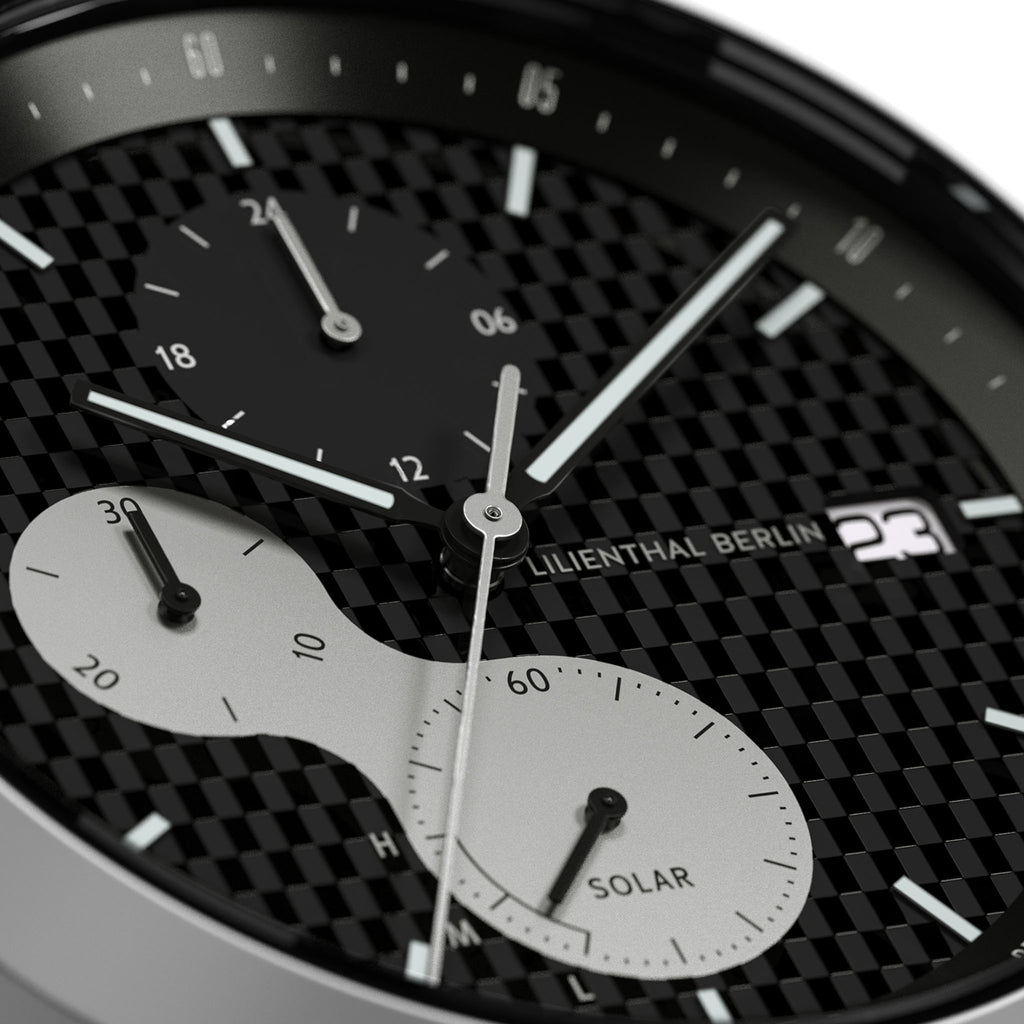 Close-up of a solar-powered chronograph watch face with subdials and date display