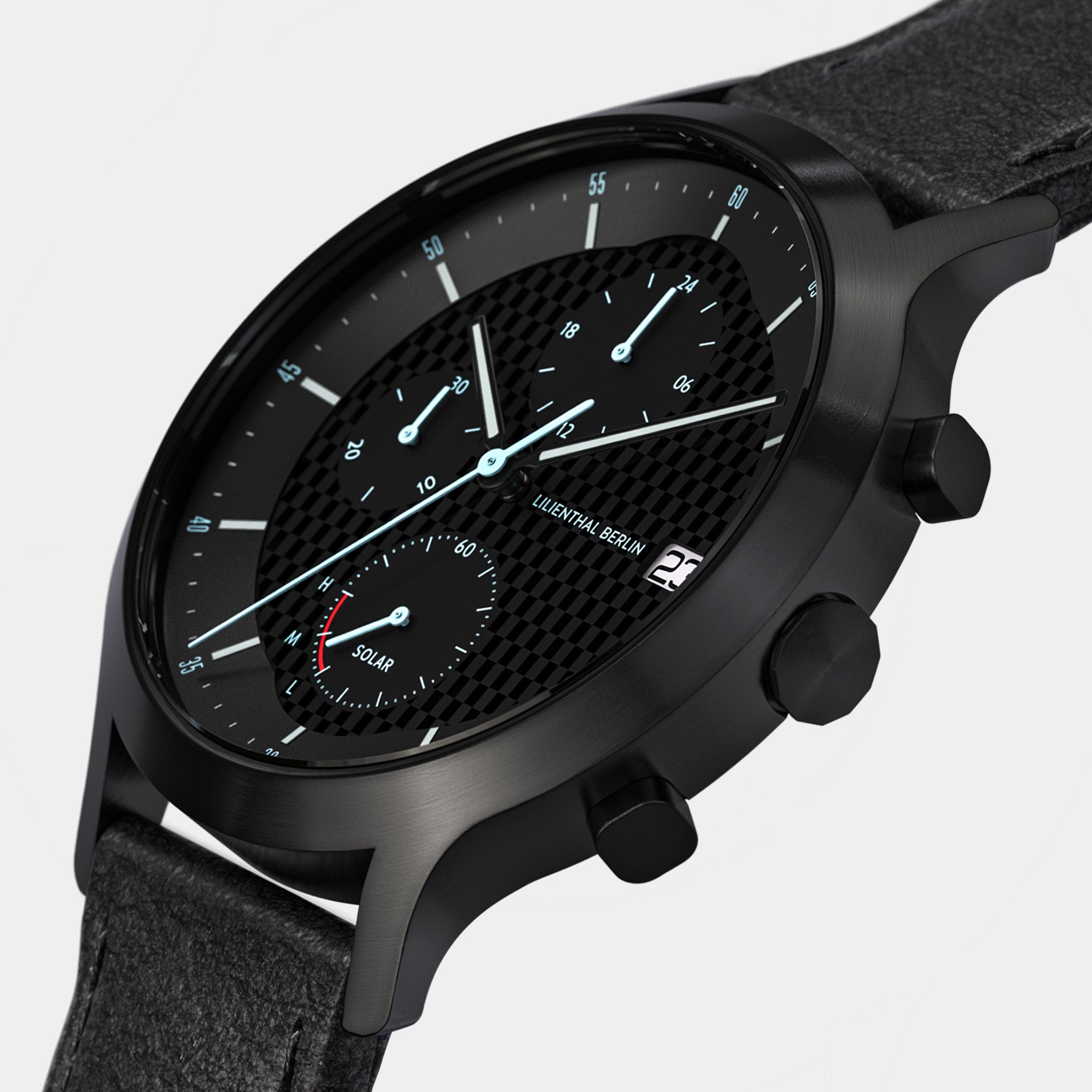 Black solar chronograph watch with textured dial, subdials, date window, and leather strap