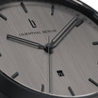 Minimalist silver analog watch face with date display and sleek hour markers