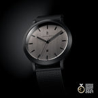 Minimalist silver and black wristwatch with mesh strap, date display, German Design Award 2021 badge