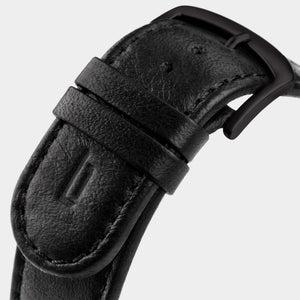 Close-up of black leather watch strap with matte black buckle