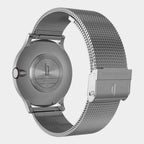 Close-up of stainless steel mesh watch band and case back with engraved details