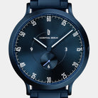 Modern blue analog wristwatch with minimalist dial and subdial on a metal band